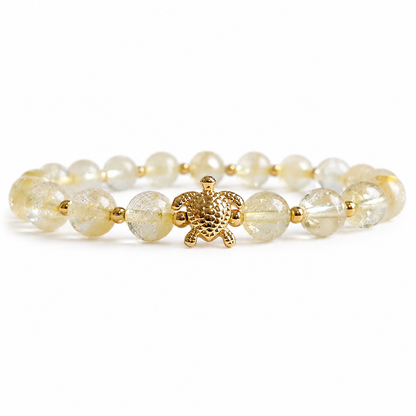 Bracelet with gold and yellow citrine stone beads on a white background