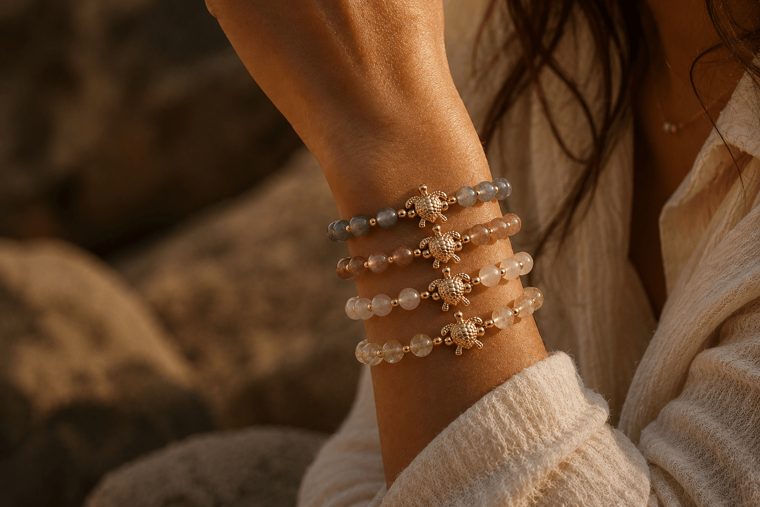 Close-up of a person's wrist wearing multiple beaded bracelets with a blurred natural background.