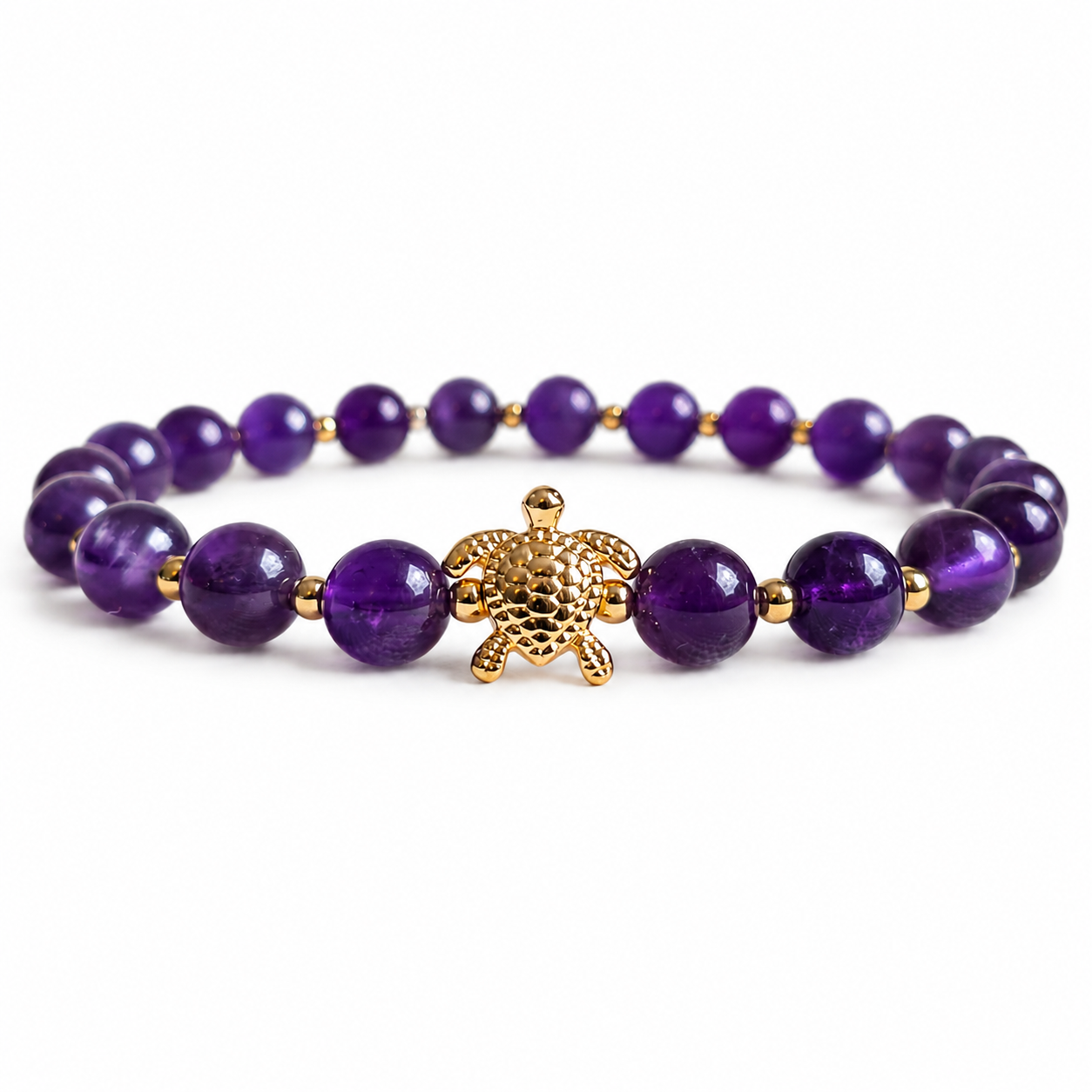 Purple Amethyst stone beaded bracelet with a gold turtle charm on a white background