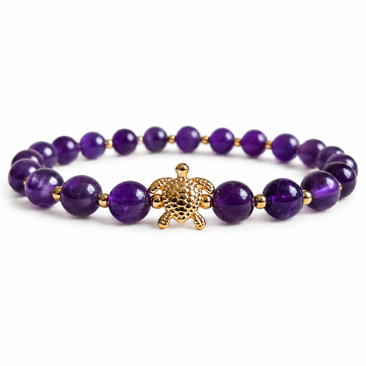 Purple Amethyst stone beaded bracelet with a gold turtle charm on a white background