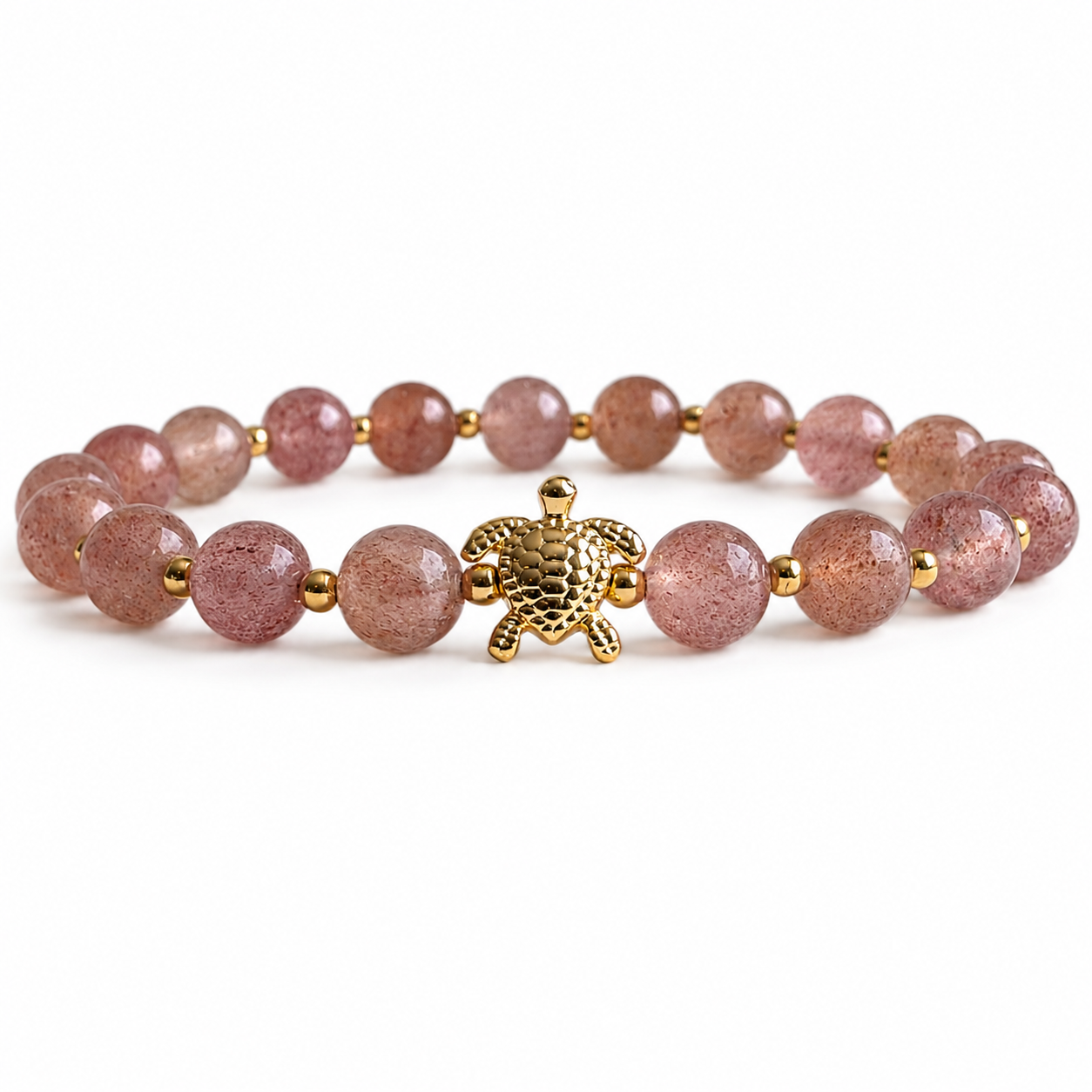 Bracelet with pink beads and a gold turtle charm on a white background