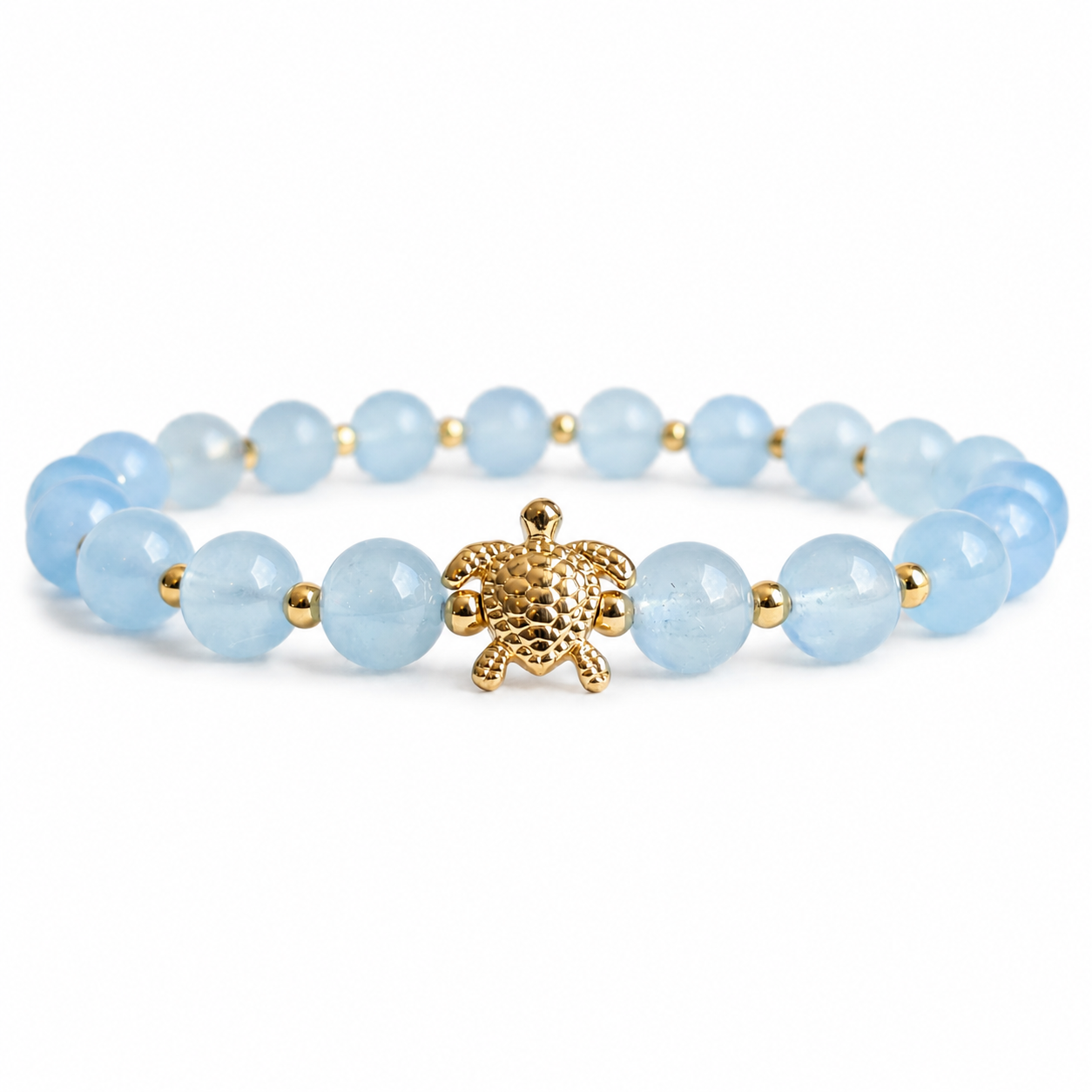 Bracelet with light blue aquamarine stone beads and a gold turtle charm on a white background